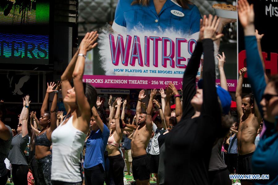 People participate in free yoga class to celebrate solstice in New York