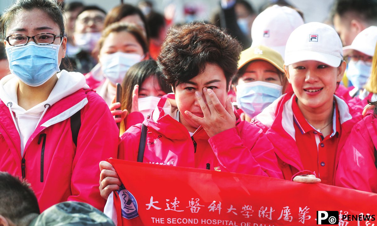 One year after outbreak, medics from around the country return to Wuhan to enjoy cherry blossoms