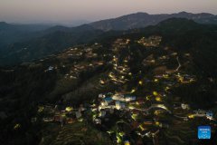 Solar powered street lamps illuminate night sky in south China