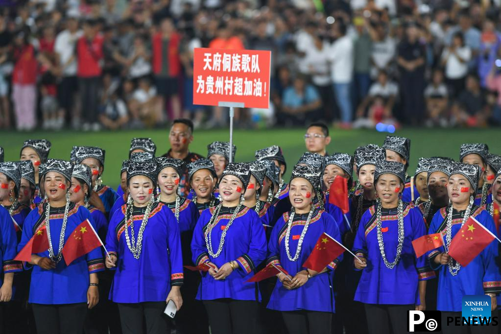 Villagers in ethnic dress give performance for "Village Super League" football match in Guizhou