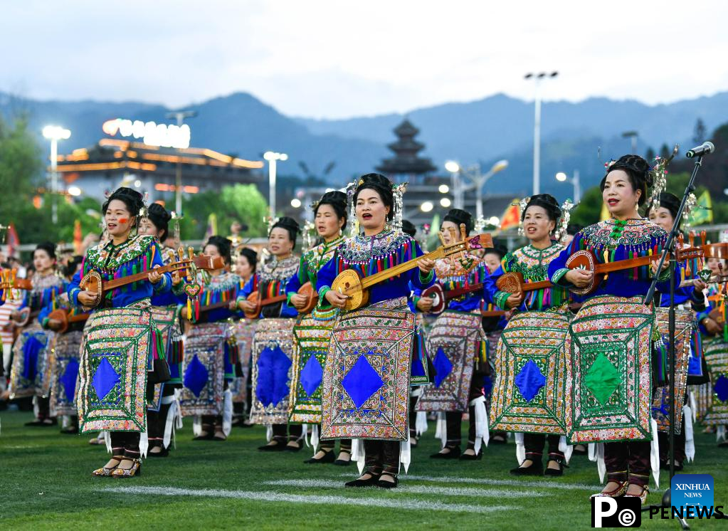 Villagers in ethnic dress give performance for "Village Super League" football match in Guizhou