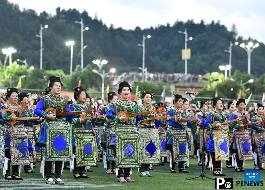 Villagers in ethnic dress give performance for "Village Super League" football match in Guizhou