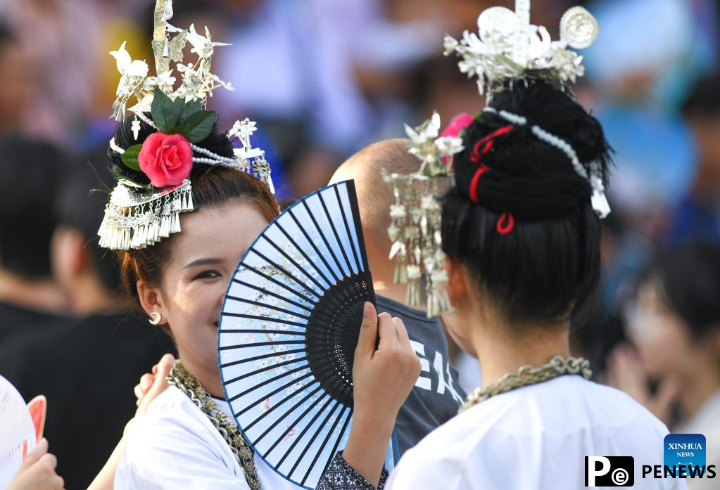 Villagers in ethnic dress give performance for "Village Super League" football match in Guizhou