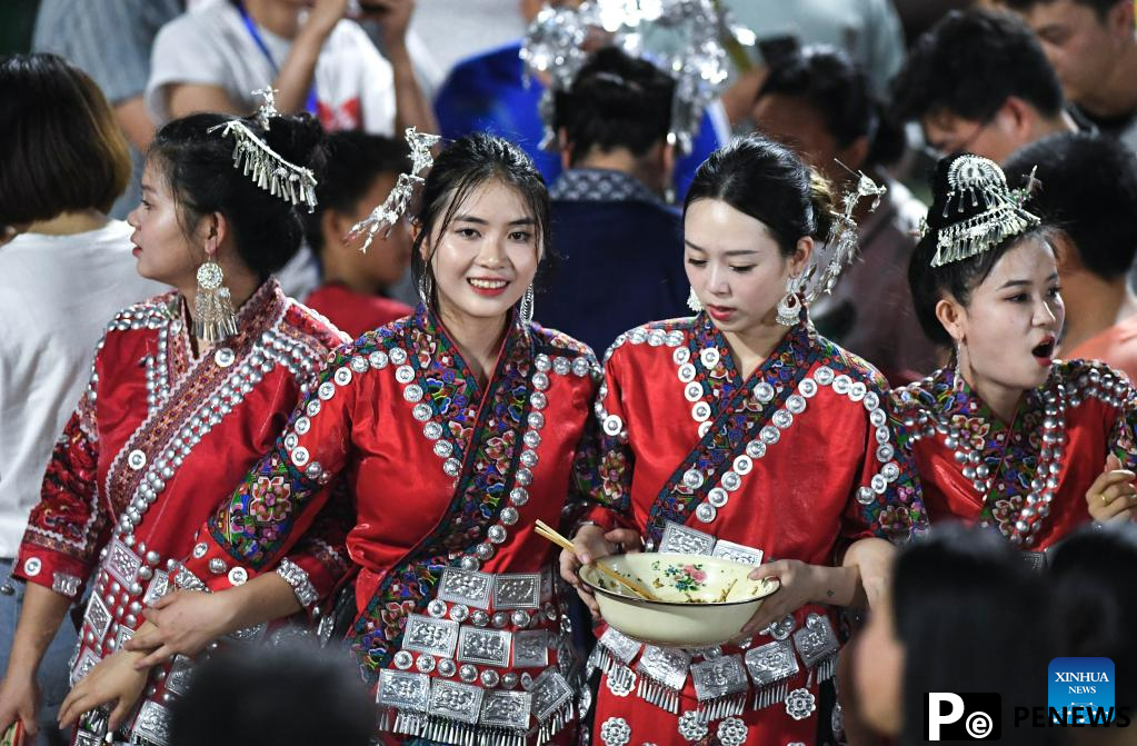 Villagers in ethnic dress give performance for "Village Super League" football match in Guizhou