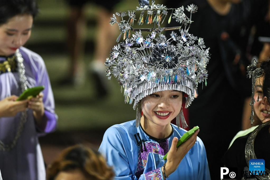 Villagers in ethnic dress give performance for "Village Super League" football match in Guizhou