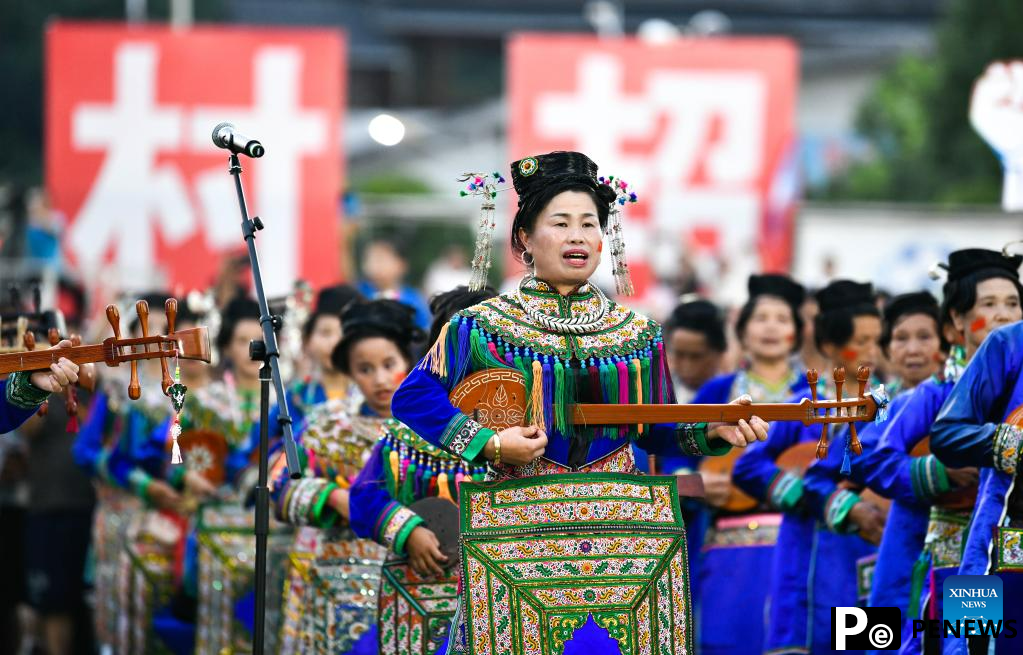 Villagers in ethnic dress give performance for "Village Super League" football match in Guizhou