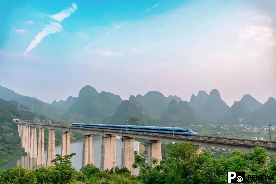 Passengers take photos of picturesque scenery as high-speed train runs in S China