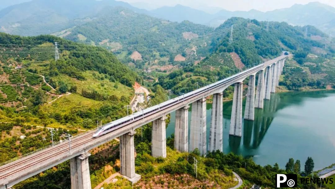 Passengers take photos of picturesque scenery as high-speed train runs in S China