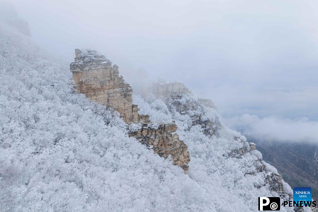 Baishi Mountain covered in snow in Laiyuan County, N China