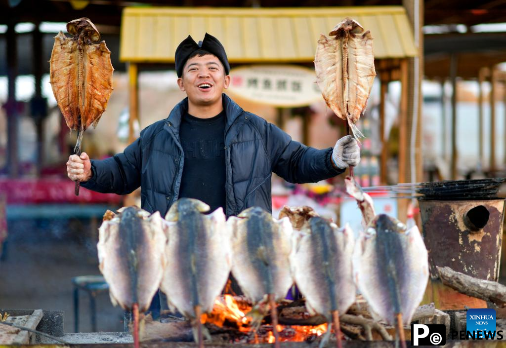 People visit desert poplar forest in Tarim River Basin of Xinjiang