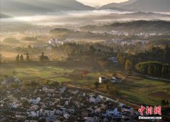 Village shrouded by mist in Autumn