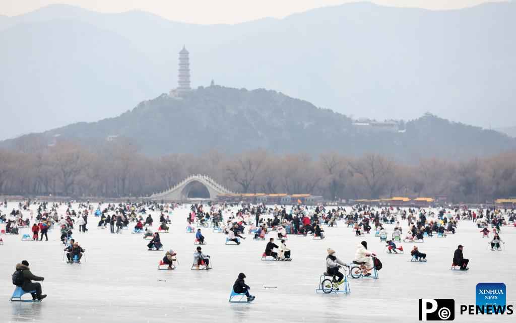 People have fun on frozen Kunming Lake at Summer Palace in Beijing