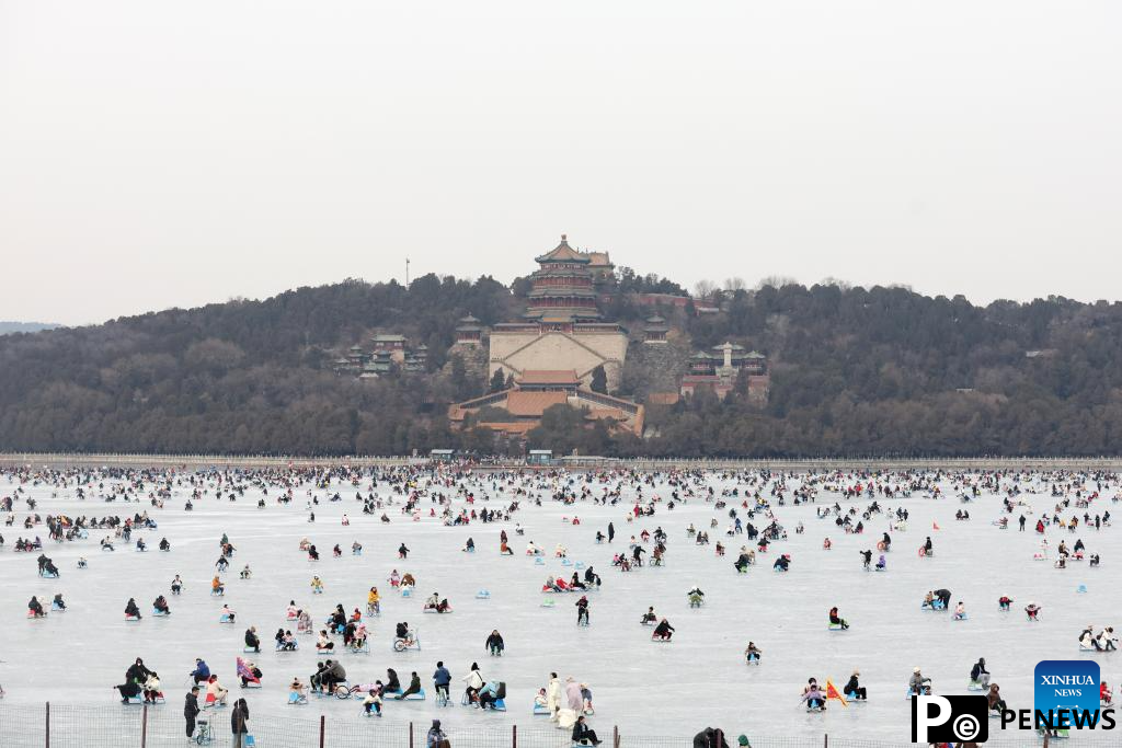 People have fun on frozen Kunming Lake at Summer Palace in Beijing