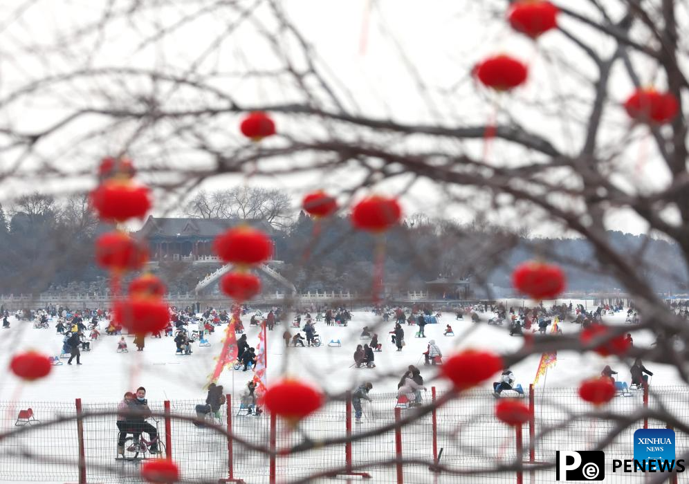 People have fun on frozen Kunming Lake at Summer Palace in Beijing