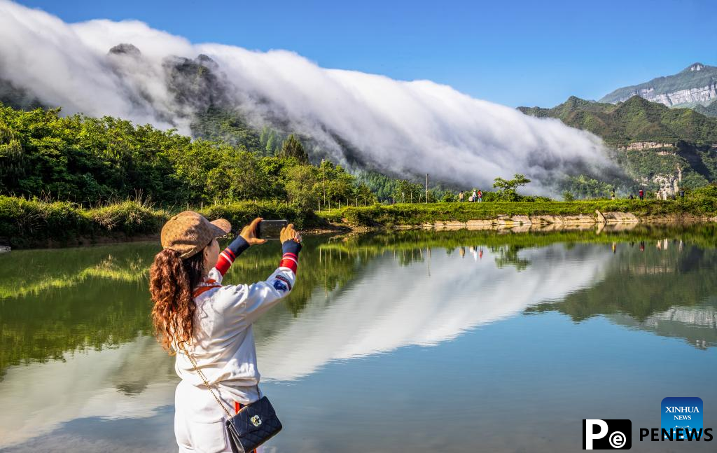 In pics: clouds streaming down Jinfo Mountain in China