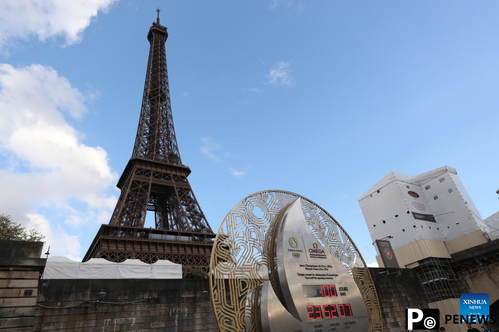 Countdown clock for Paris 2024 Olympic Games seen in front of Eiffel Tower