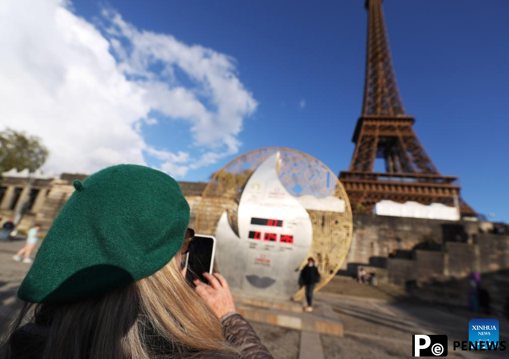 Countdown clock for Paris 2024 Olympic Games seen in front of Eiffel Tower