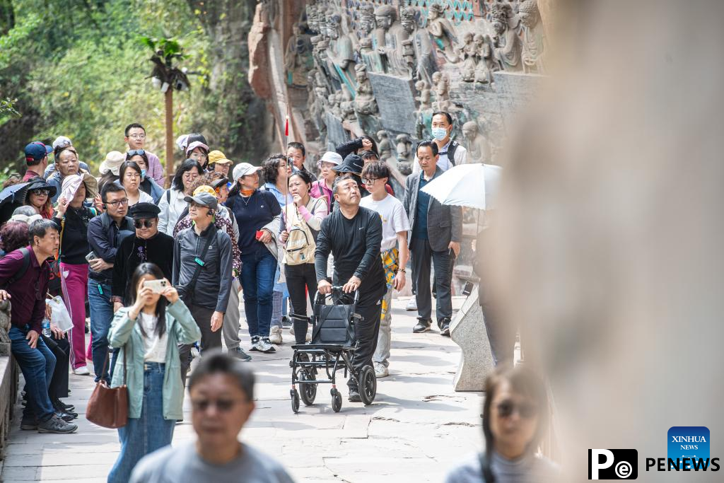 Tourists visit Dazu Rock Carvings in Chongqing