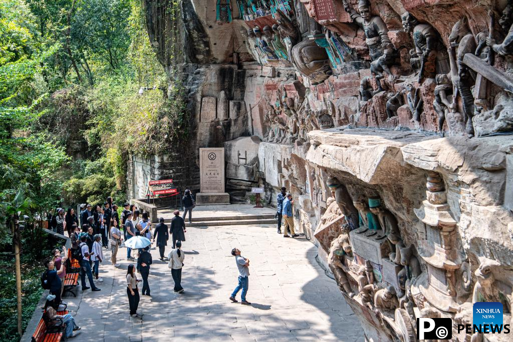 Tourists visit Dazu Rock Carvings in Chongqing