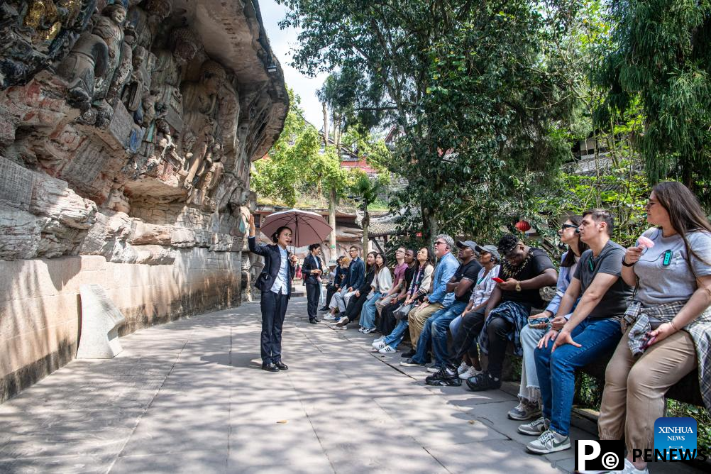 Tourists visit Dazu Rock Carvings in Chongqing