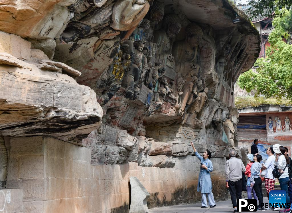 Tourists visit Dazu Rock Carvings in Chongqing