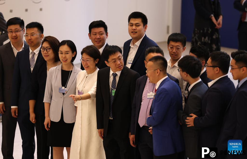 Participants interact during Summer Davos