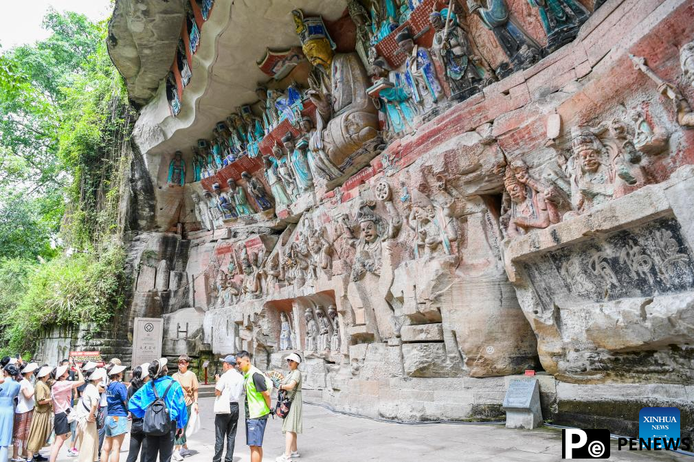 Tourists visit scenic spot of Dazu Rock Carvings in China