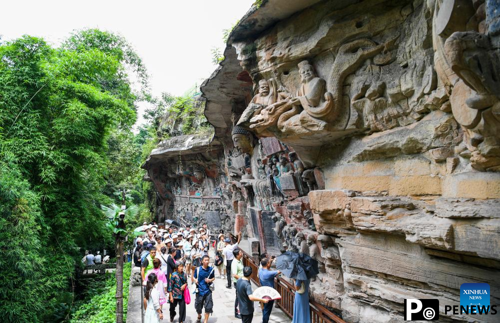 Tourists visit scenic spot of Dazu Rock Carvings in China