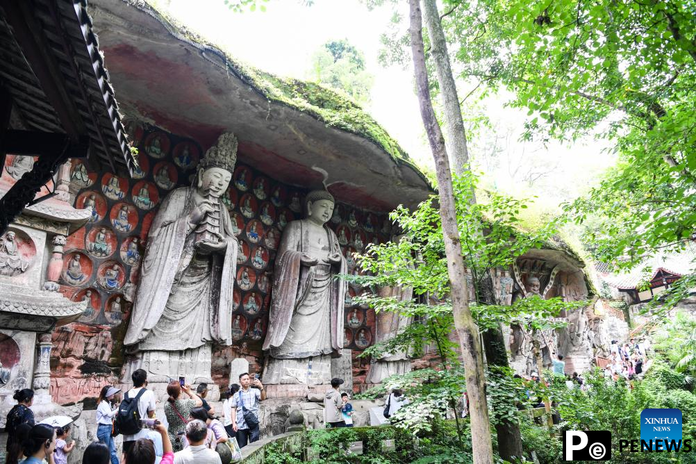 Tourists visit scenic spot of Dazu Rock Carvings in China