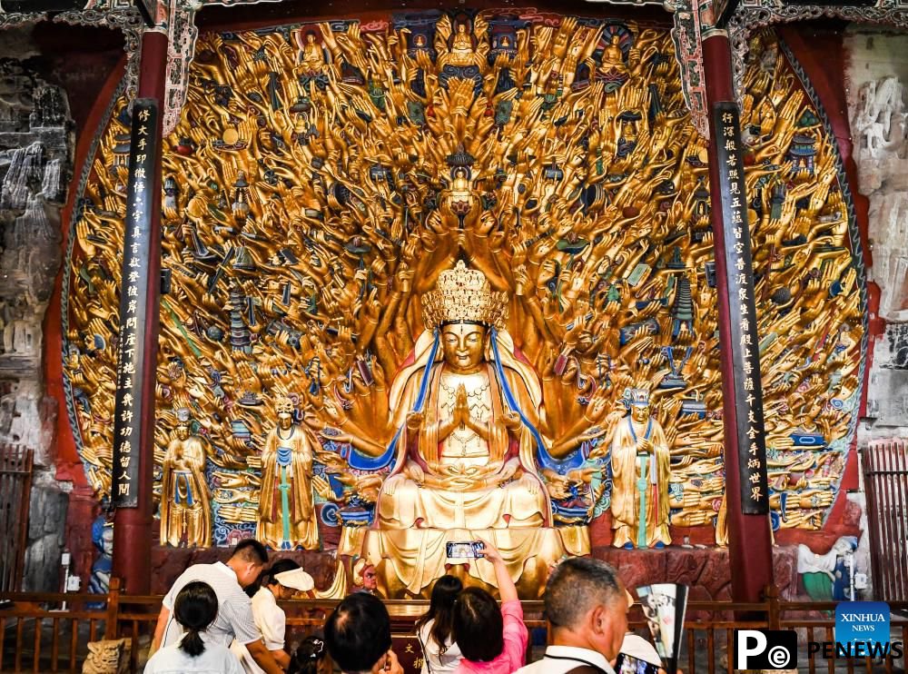 Tourists visit scenic spot of Dazu Rock Carvings in China