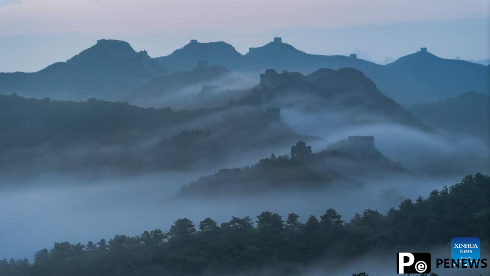 Scenery of Jinshanling section of Great Wall shrouded in clouds in Hebei
