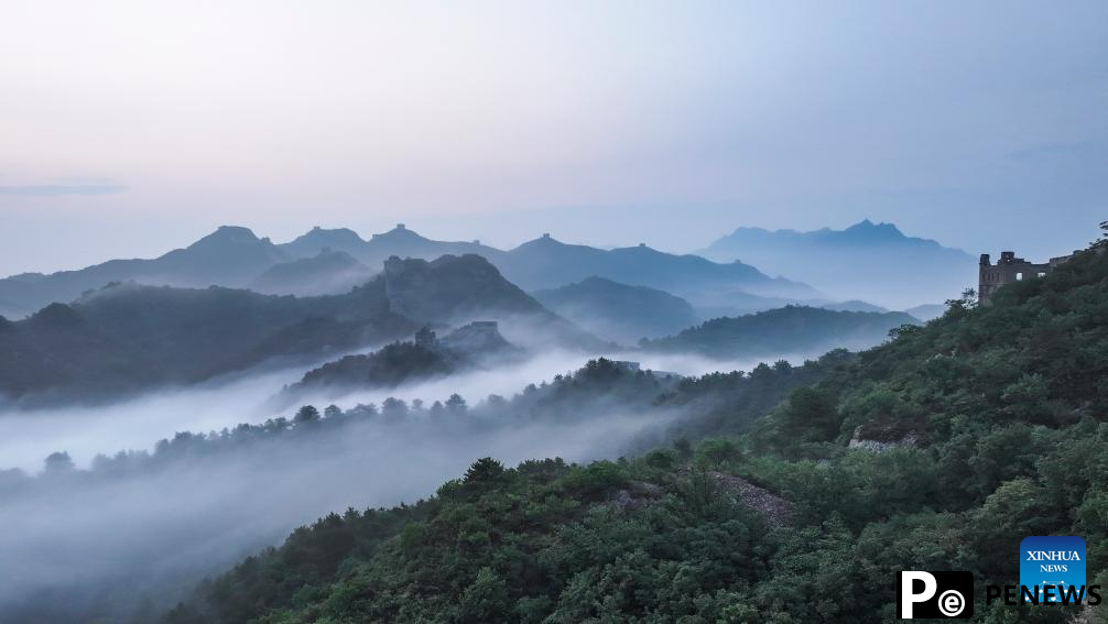 Scenery of Jinshanling section of Great Wall shrouded in clouds in Hebei