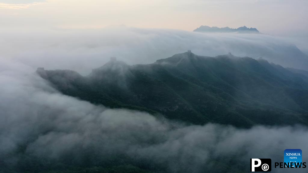 Scenery of Jinshanling section of Great Wall shrouded in clouds in Hebei