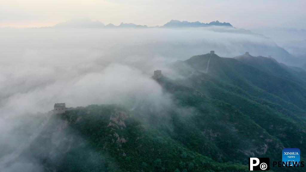 Scenery of Jinshanling section of Great Wall shrouded in clouds in Hebei
