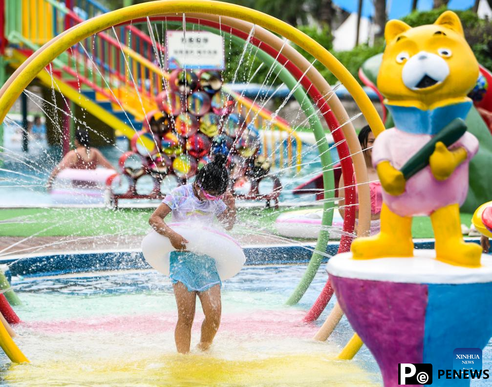Tourists have fun at water park in Fuling District, SW China