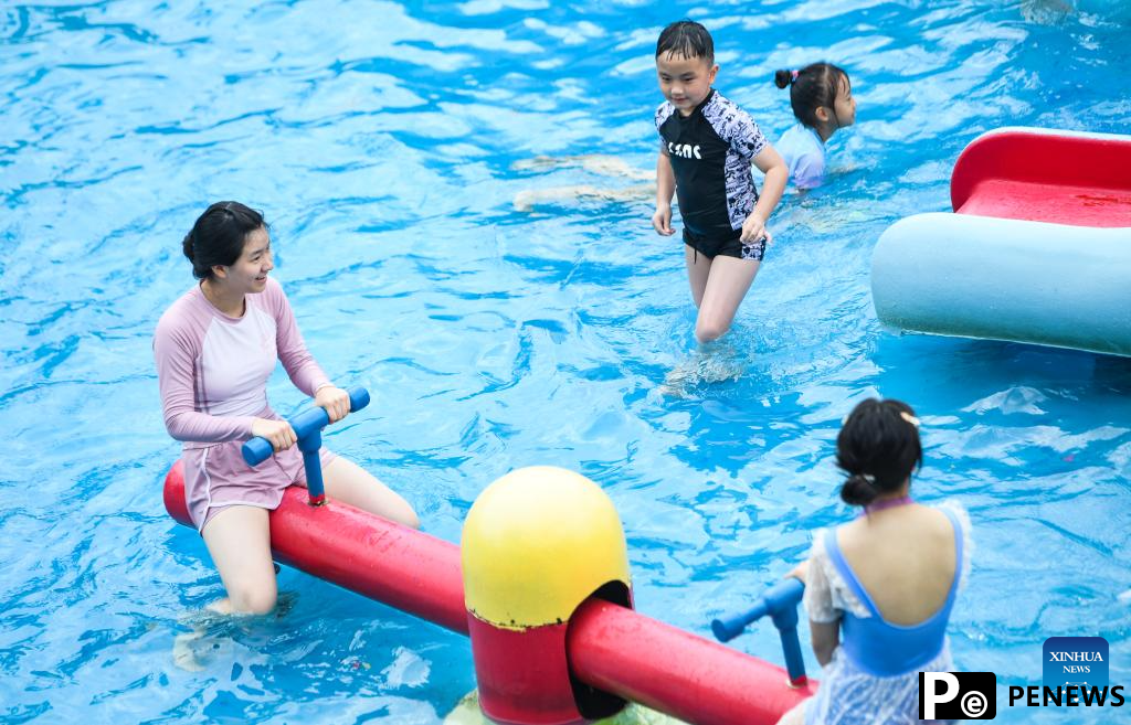 Tourists have fun at water park in Fuling District, SW China
