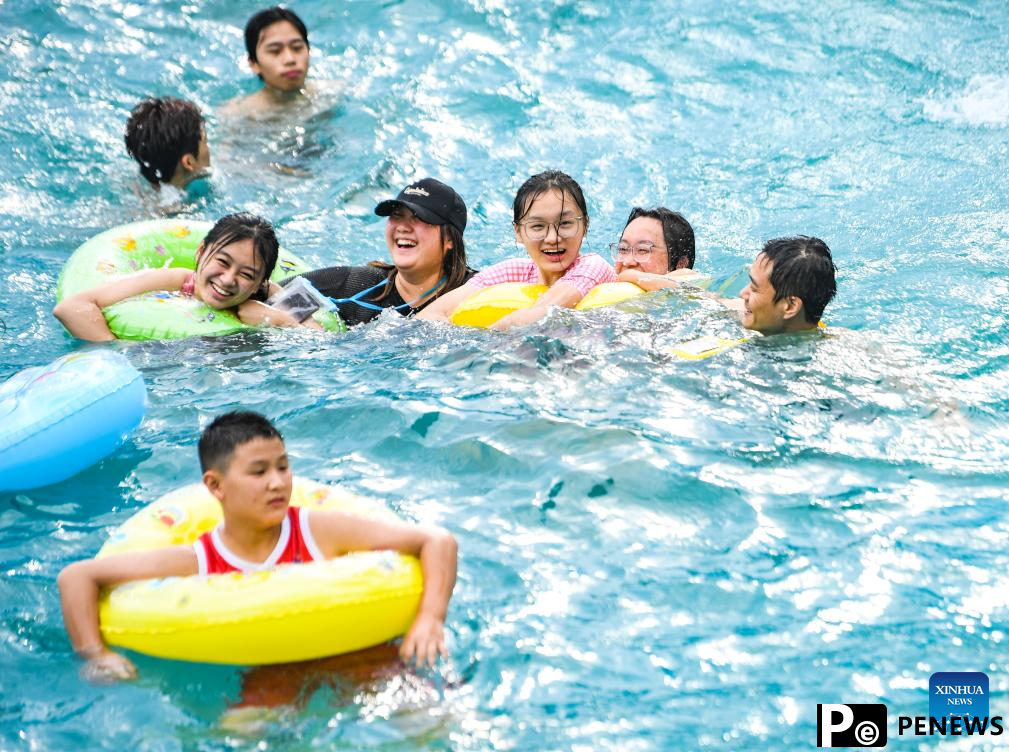 Tourists have fun at water park in Fuling District, SW China
