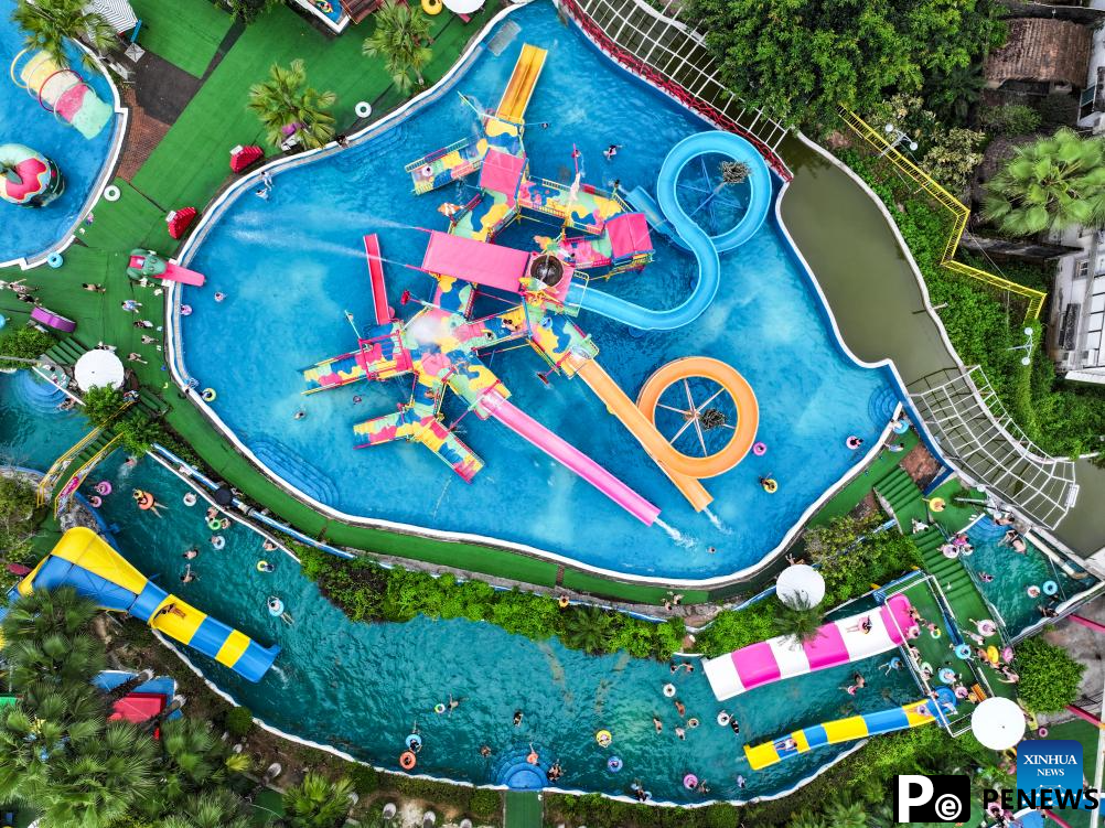 Tourists have fun at water park in Fuling District, SW China