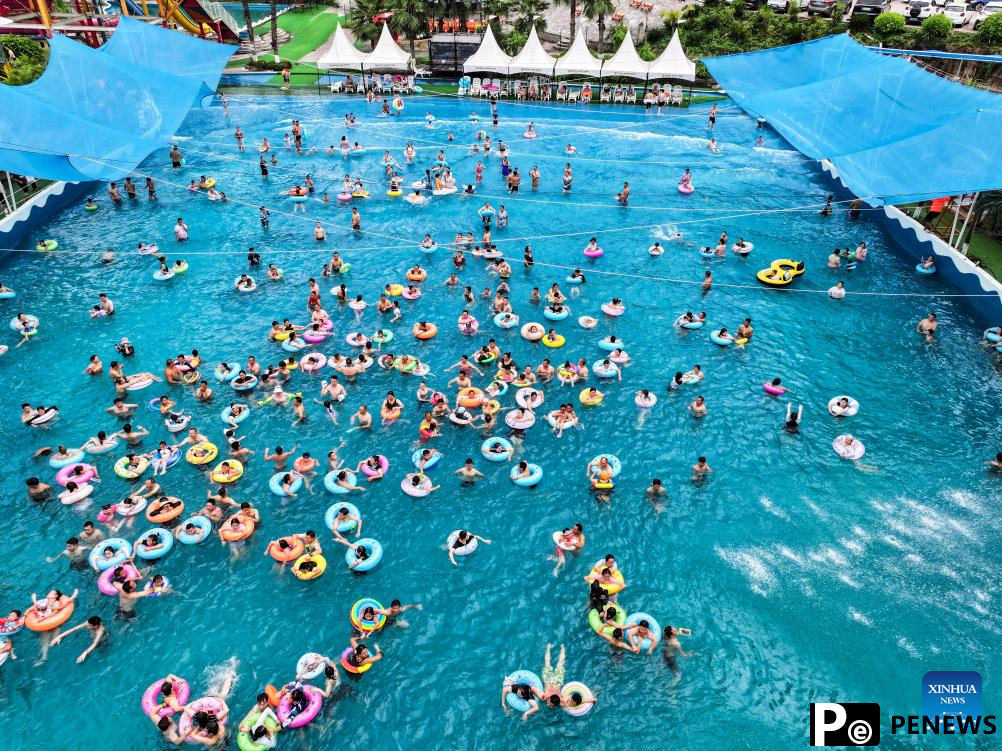 Tourists have fun at water park in Fuling District, SW China