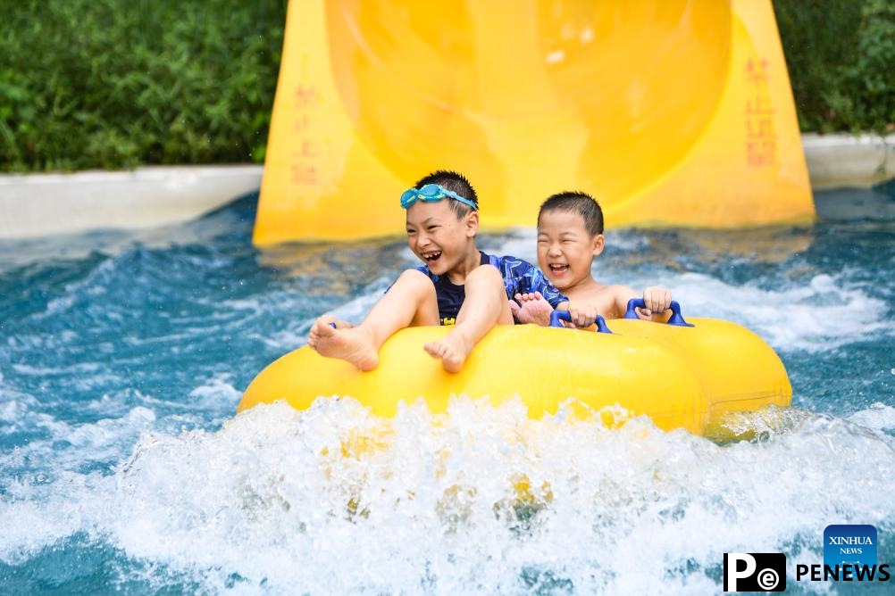 Tourists have fun at water park in Fuling District, SW China