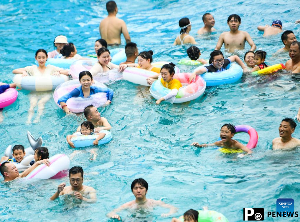 Tourists have fun at water park in Fuling District, SW China