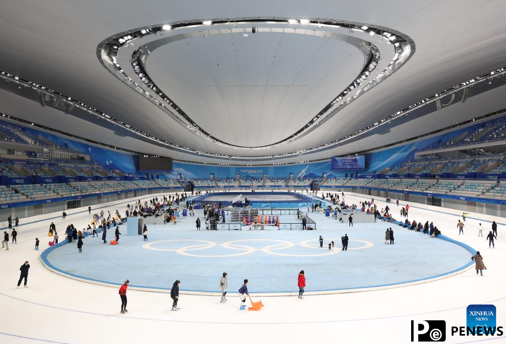People have fun with ice and snow at National Speed Skating Oval in Beijing