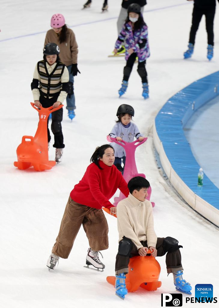 People have fun with ice and snow at National Speed Skating Oval in Beijing