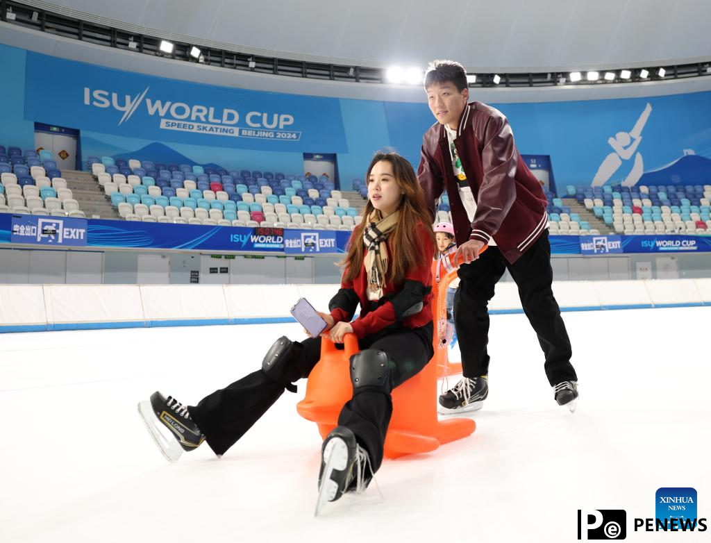 People have fun with ice and snow at National Speed Skating Oval in Beijing