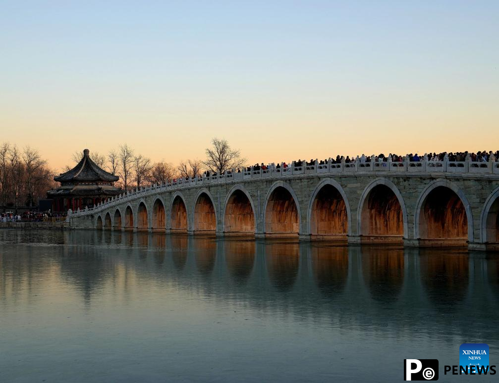People visit 17-Arch Bridge in Summer Palace, China