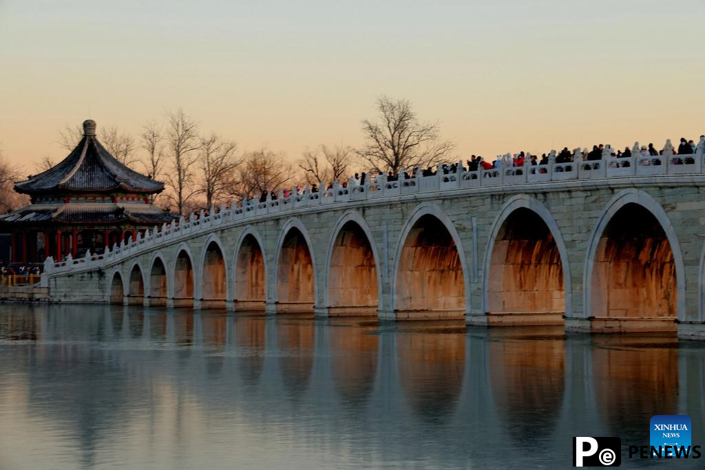 People visit 17-Arch Bridge in Summer Palace, China