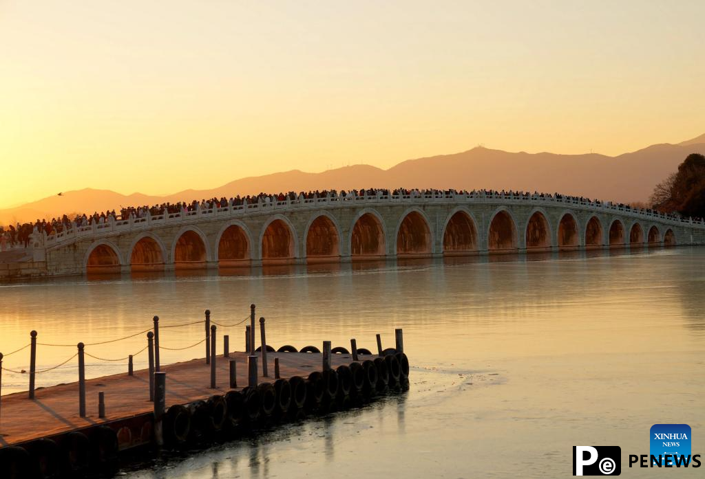 People visit 17-Arch Bridge in Summer Palace, China