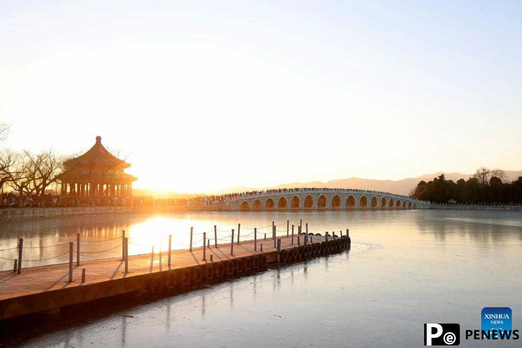 People visit 17-Arch Bridge in Summer Palace, China