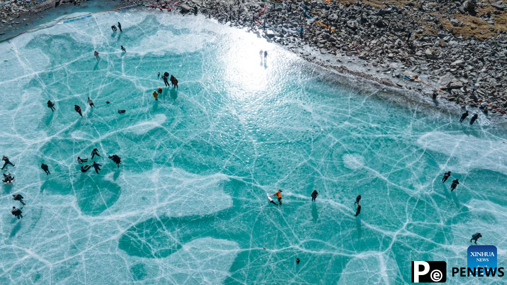 Tourists have fun on icy lake in Lhasa, China
