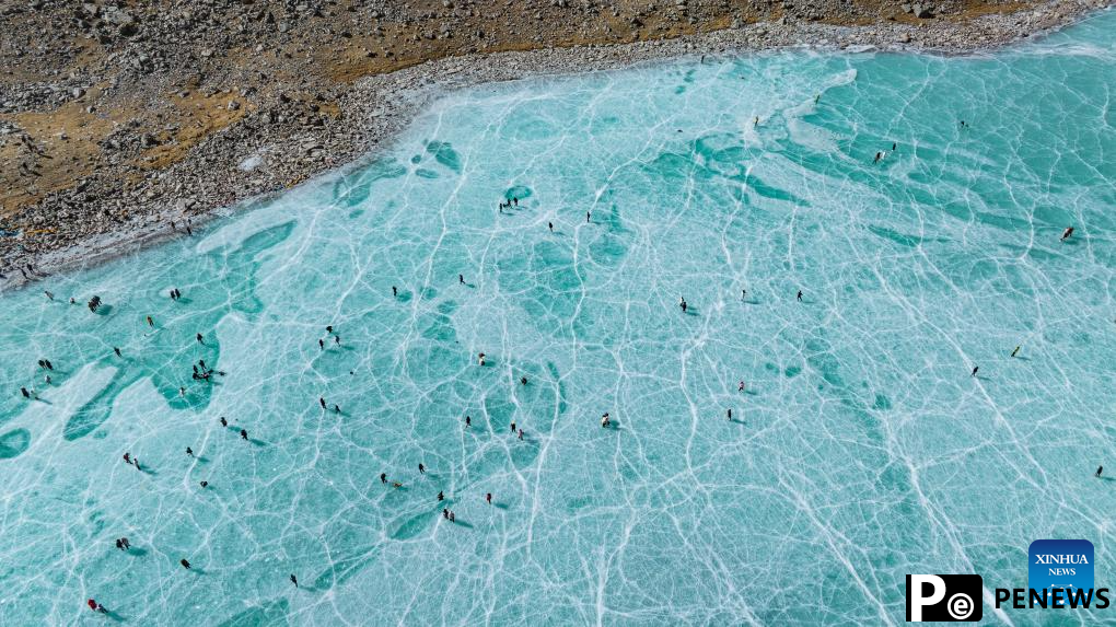 Tourists have fun on icy lake in Lhasa, China